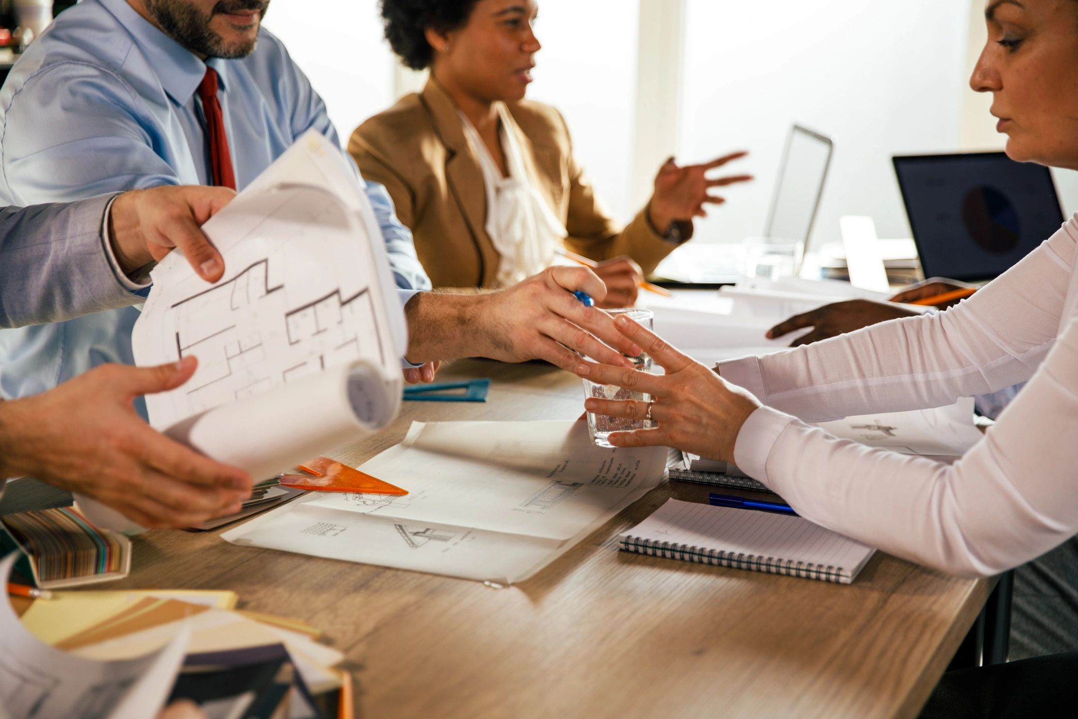 Team reviewing blueprints for sustainable infrastructure planning
