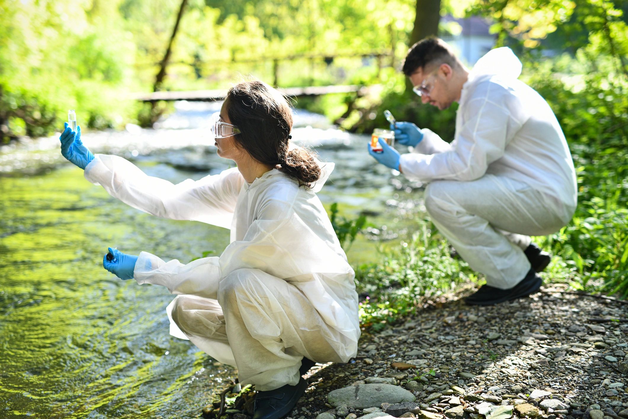 Scientists collecting river water samples for quality monitoring