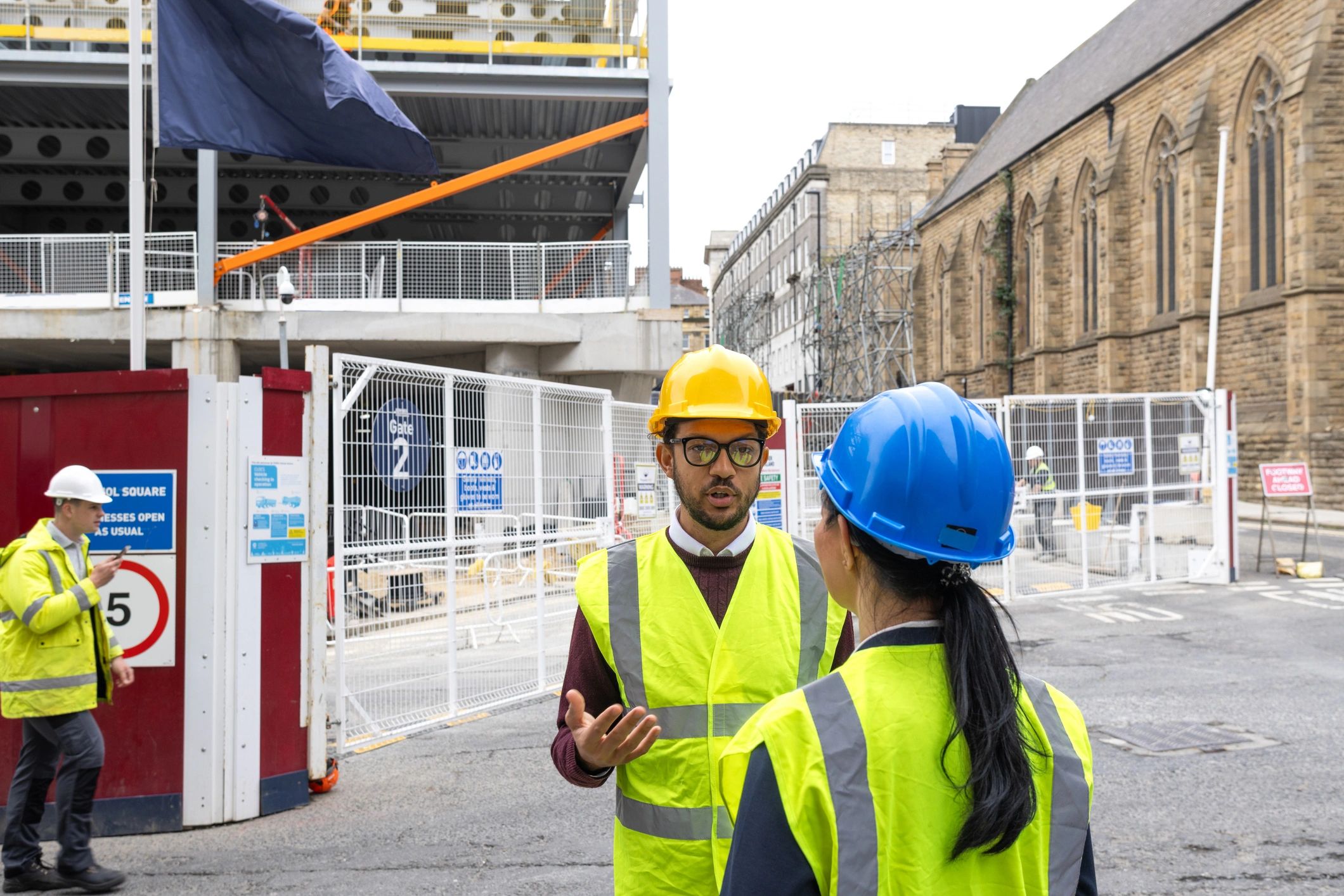 Public works staff discussing plans on a job site