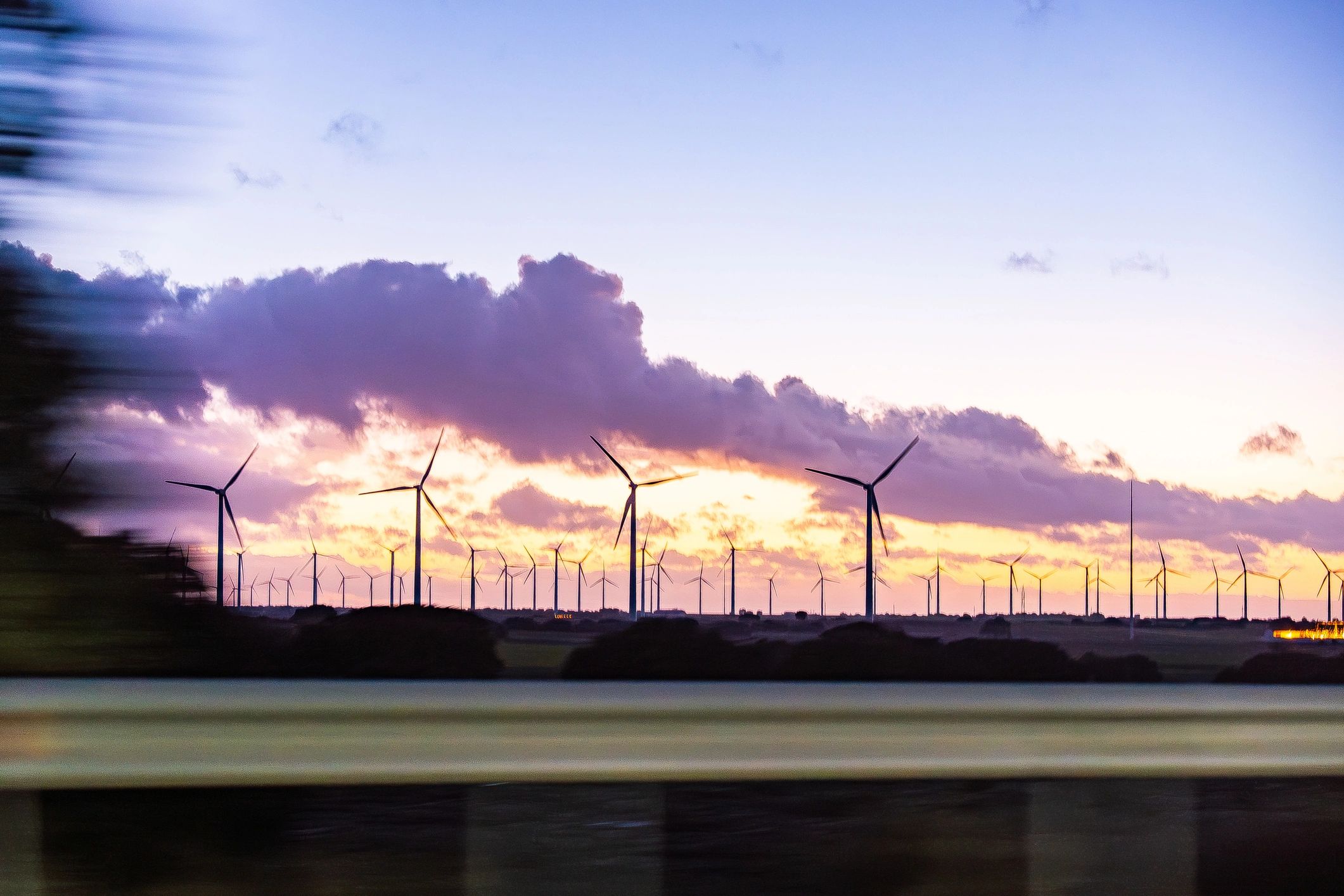 Wind turbines at sunset representing clean energy development
